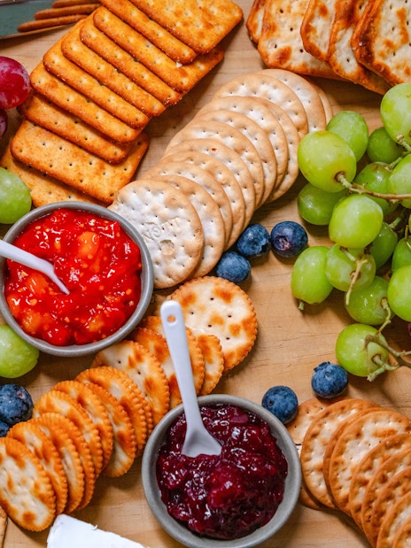 Platter with grapes, crackers, cheeses, and dips for guests on the cruise.