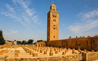 Koutoubia Mosque tower in Marrakech under a clear blue sky.