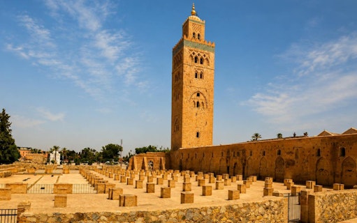 Koutoubia Mosque tower in Marrakech under a clear blue sky.