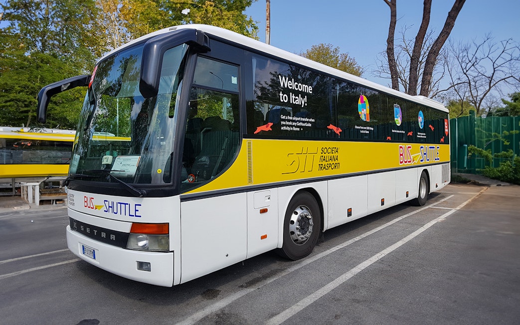 SIT Bus Shuttle parked in a lot, offering transport services in Italy.
