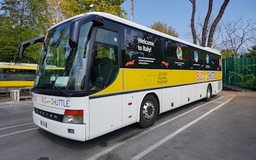 SIT Bus Shuttle parked in a lot, offering transport services in Italy.