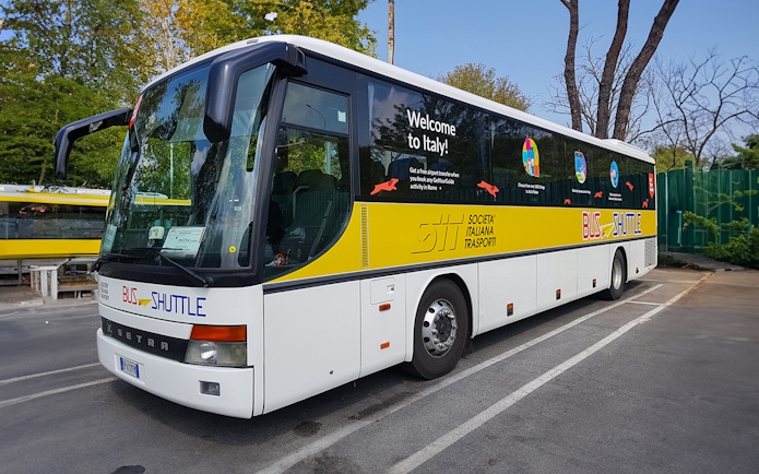 SIT Bus Shuttle parked in a lot, offering transport services in Italy.