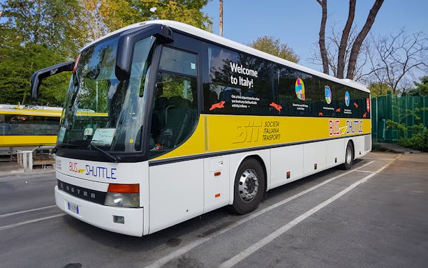 SIT Bus Shuttle parked in a lot, offering transport services in Italy.