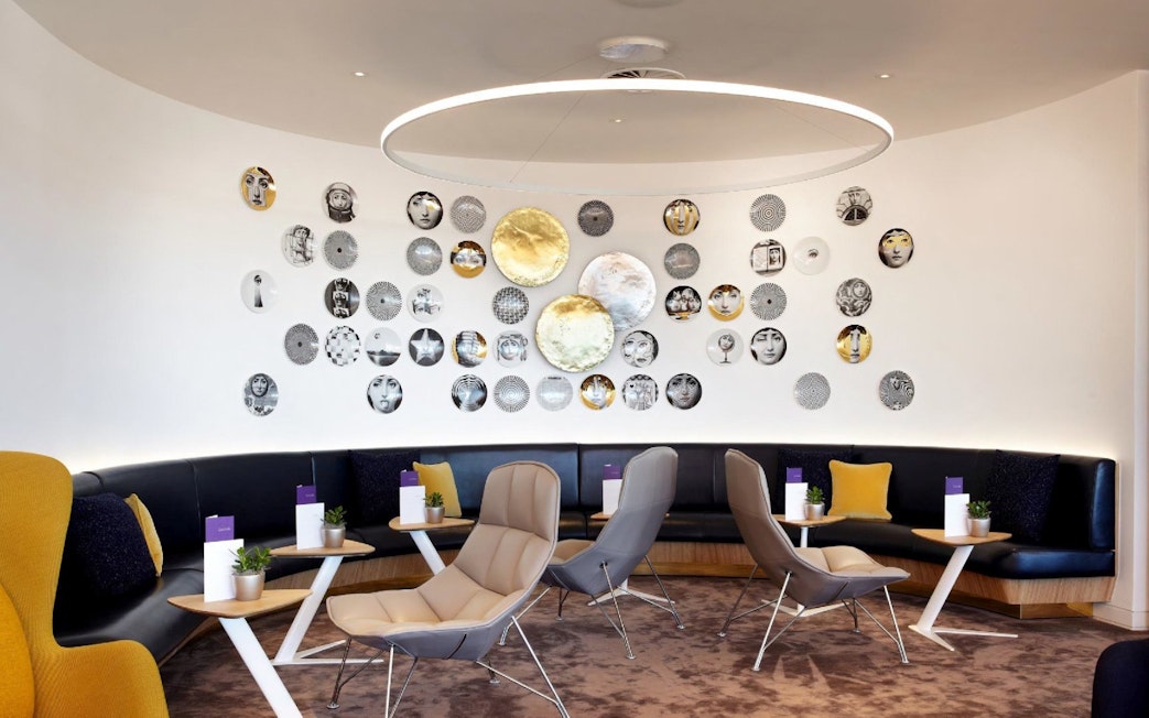 Seating area with modern decor at Plaza Premium Lounge, Departures, North Terminal, London Gatwick Airport.