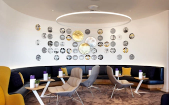 Seating area with modern decor at Plaza Premium Lounge, Departures, North Terminal, London Gatwick Airport.