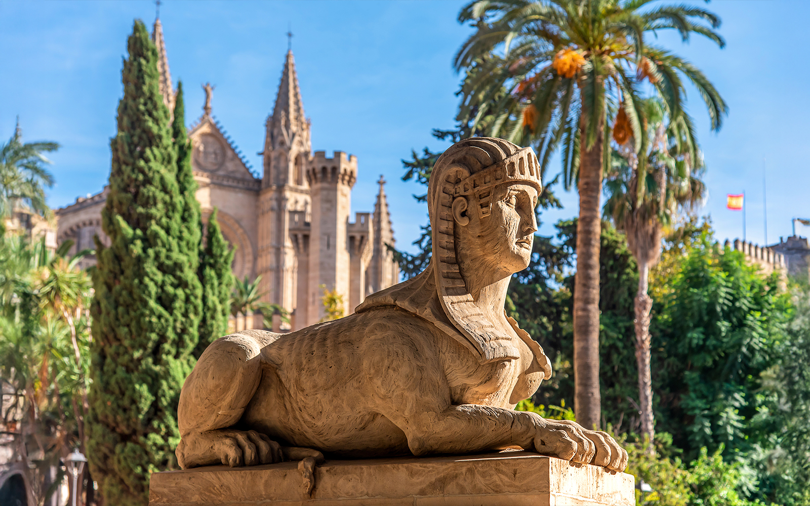 Sphinx statue with Palma de Mallorca Cathedral in the background.