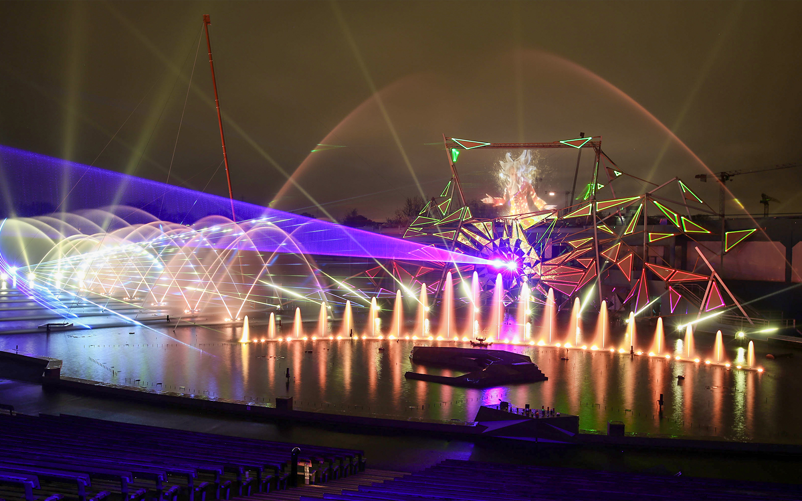 Futuroscope night show with colorful lights and water fountains in Poitiers, France.