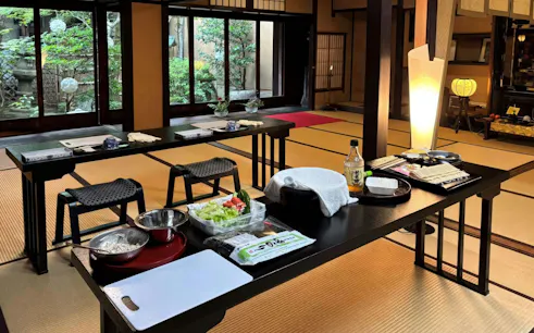 Sushi class setup with ingredients and tools in a traditional Kyoto room.