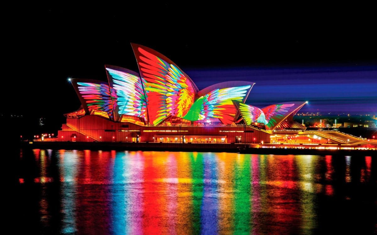 Sydney Opera House illuminated with colorful lights during Vivid Sydney festival.