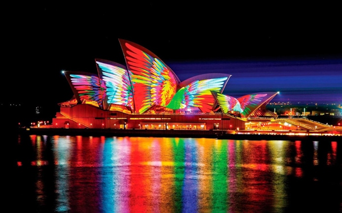 Sydney Opera House illuminated with colorful lights during Vivid Sydney festival.