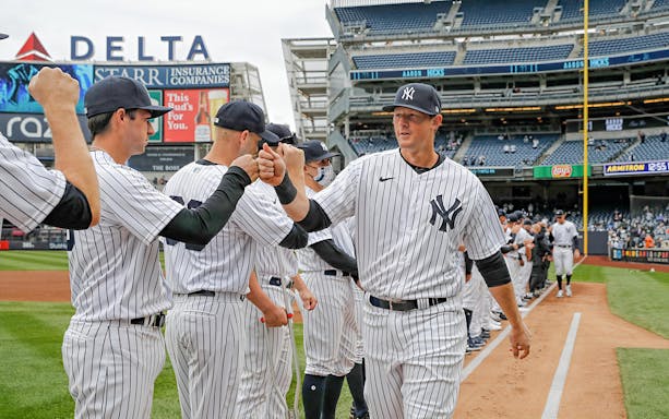 New York Yankees players greeting each other on the field before the game against Detroit Tigers.