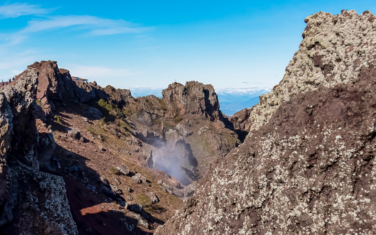 Volcanic landscape of Mount Vesuvius crater with rocky terrain and distant views.