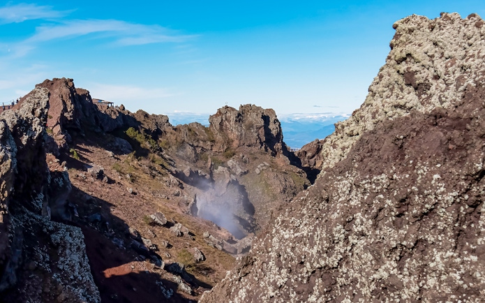Volcanic landscape of Mount Vesuvius crater with rocky terrain and distant views.
