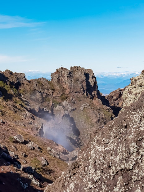 Volcanic landscape of Mount Vesuvius crater with rocky terrain and distant views.