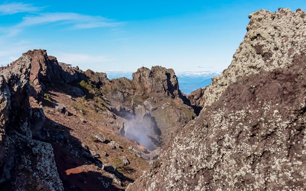 Volcanic landscape of Mount Vesuvius crater with rocky terrain and distant views.