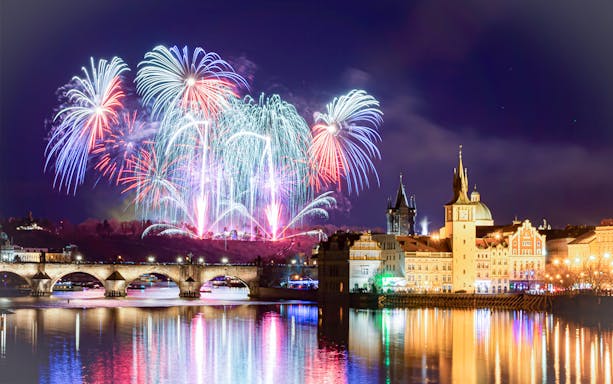 Fireworks over Charles Bridge and Vltava River in Prague on New Year's Eve.
