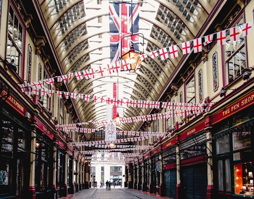 Borough Market arcade with flags, part of Harry Potter film locations tour in London.