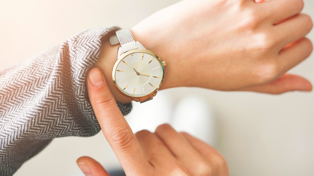 Person checking time on wristwatch.