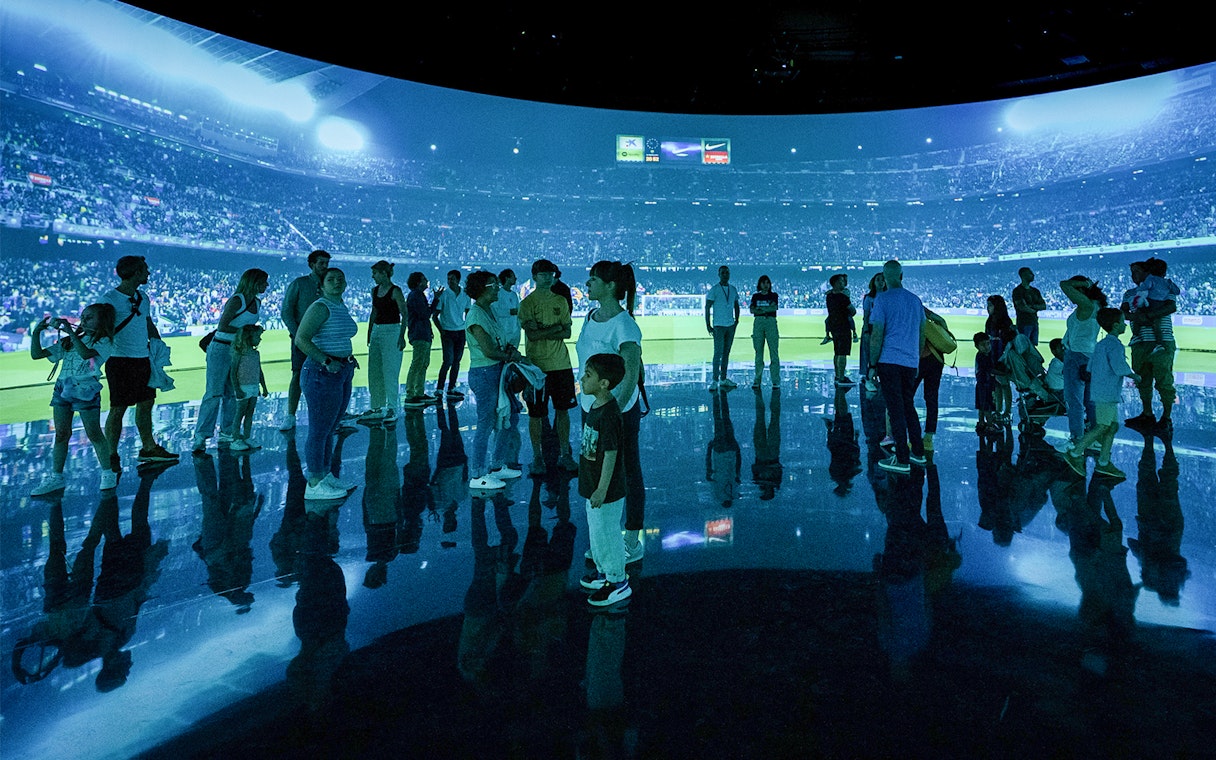 Visitors at FC Barcelona immersive stadium tour experience.