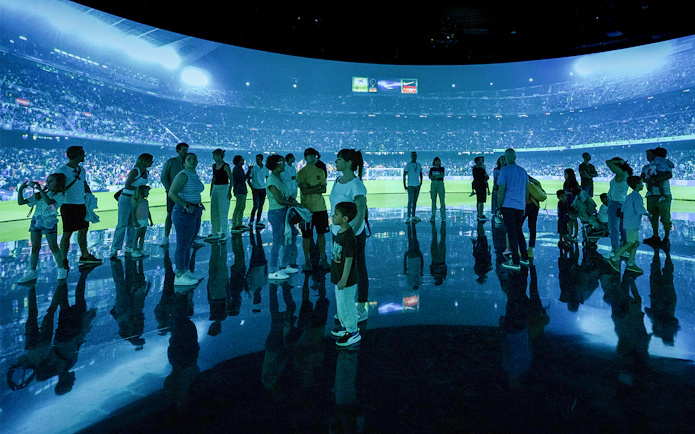 Visitors at FC Barcelona immersive stadium tour experience.