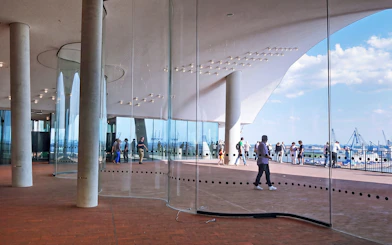 Visitors on the Plaza of Elbphilharmonie overlooking the harbor in Hamburg, Germany.