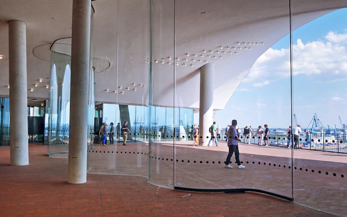 Visitors on the Plaza of Elbphilharmonie overlooking the harbor in Hamburg, Germany.