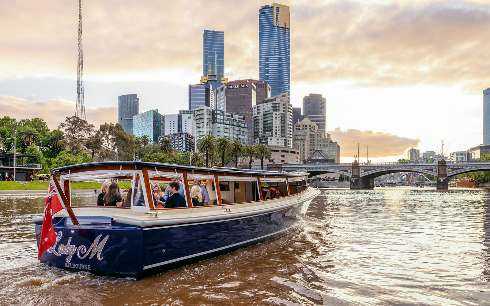 Yarra River sunset cruise with city skyline view, Melbourne.