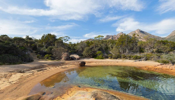 Honeymoon Bay Bruny Island Tasmania with clear waters and rocky shoreline.