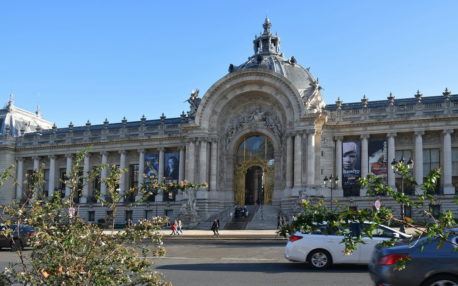 Petit Palais facade with ornate entrance and banners, Paris.