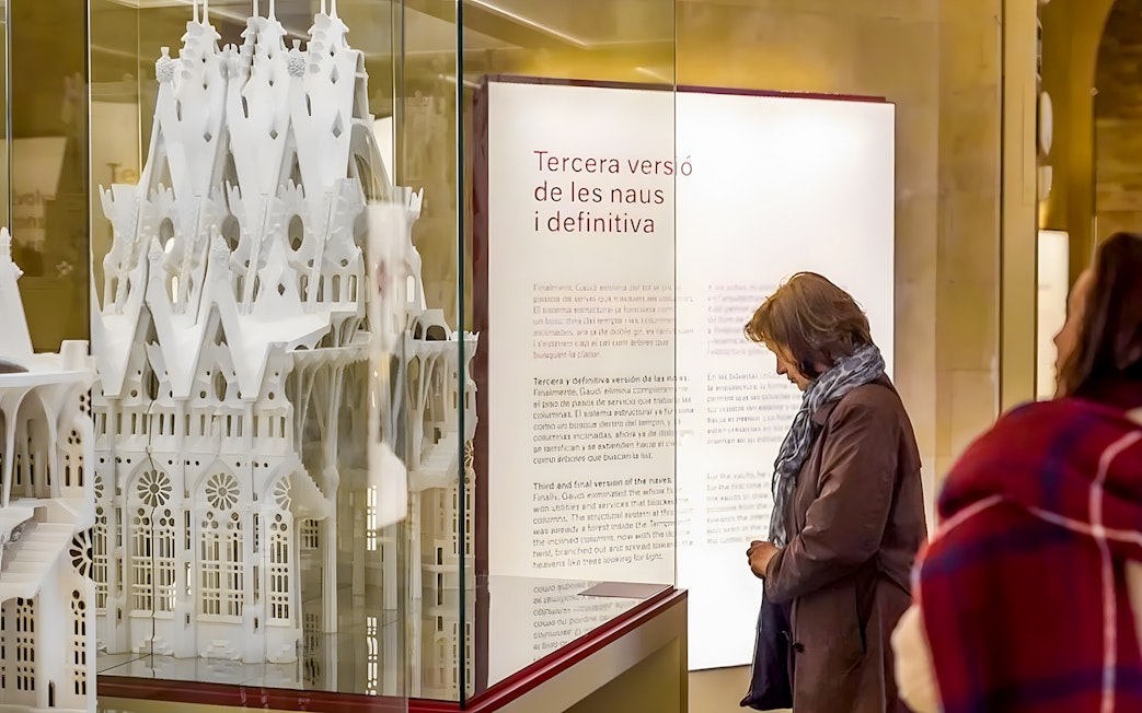 Sagrada Familia museum visitor observing architectural model display.