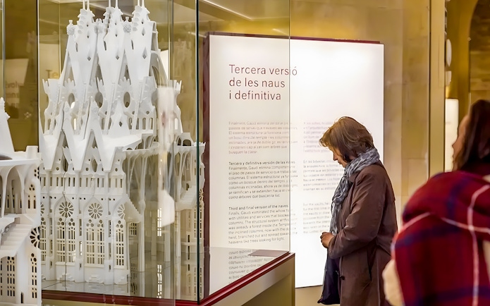 Sagrada Familia museum visitor observing architectural model display.