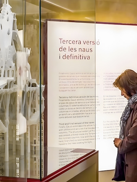 Sagrada Familia museum visitor observing architectural model display.