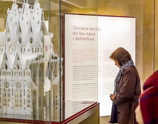 Sagrada Familia museum visitor observing architectural model display.
