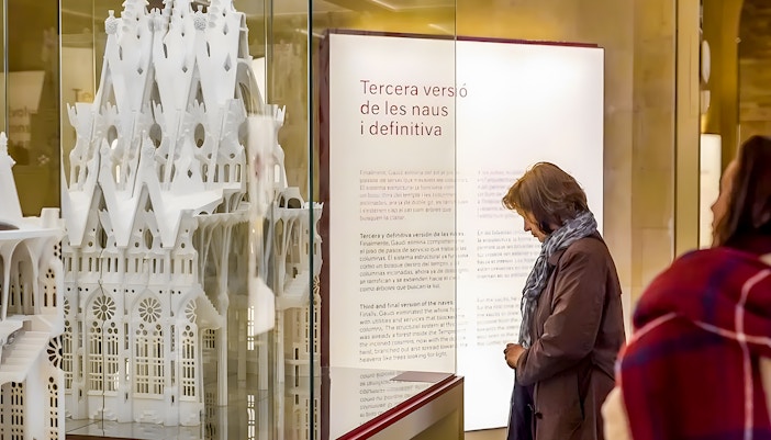 Sagrada Familia museum visitor observing architectural model display.