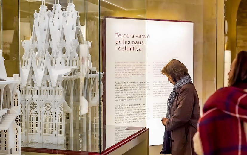 Sagrada Familia museum visitor observing architectural model display.