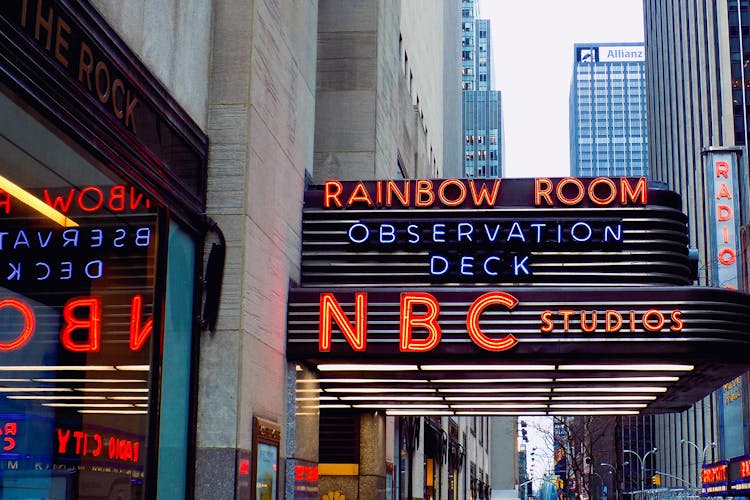 NBC Studios neon sign at Rockefeller Center during guided tour in New York City.