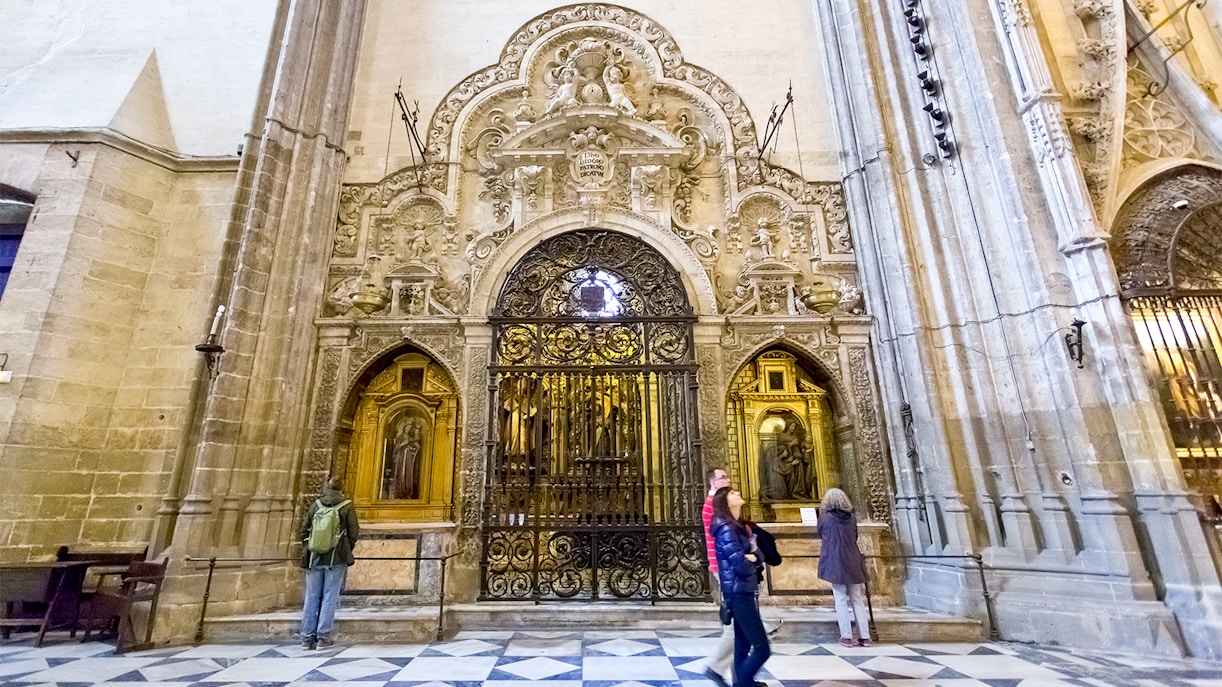 Seville Cathedral entrance with tourists using fast track tickets.