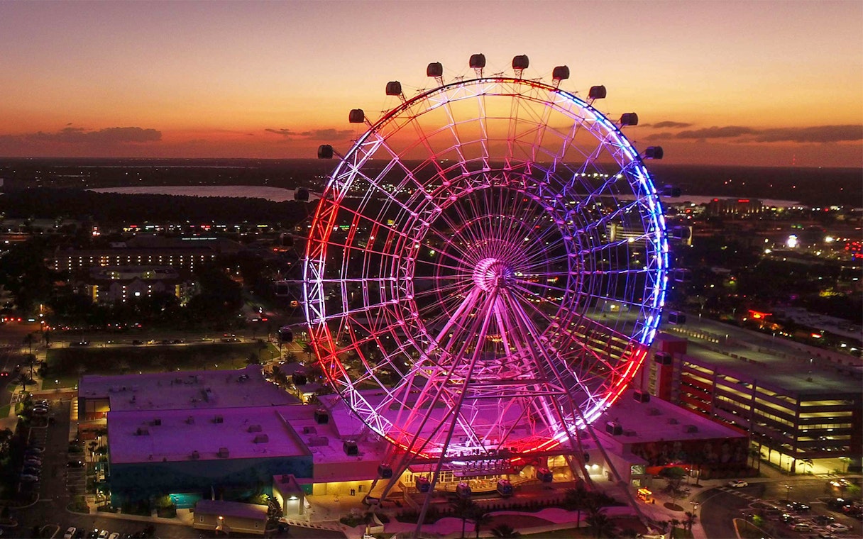 Orlando Ferris wheel lit up at sunset, part of the Orlando Explorer Pass by Go City.