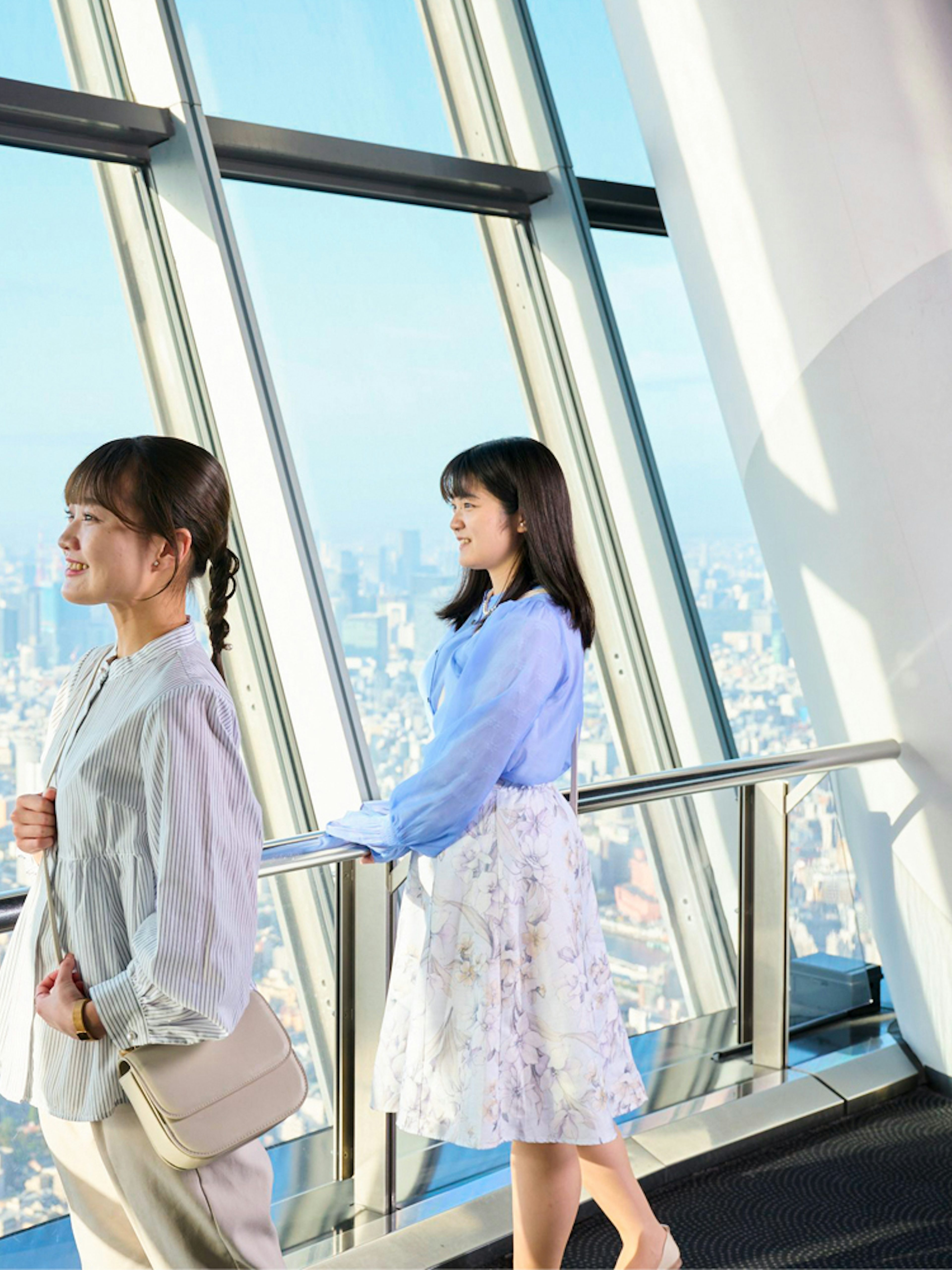 Tourists enjoying city view from Tembo Deck in Tokyo Skytree.
