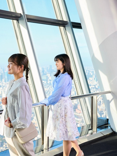 Tourists enjoying city view from Tembo Deck in Tokyo Skytree.