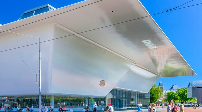 Stedelijk Museum Amsterdam exterior with visitors and cyclist.