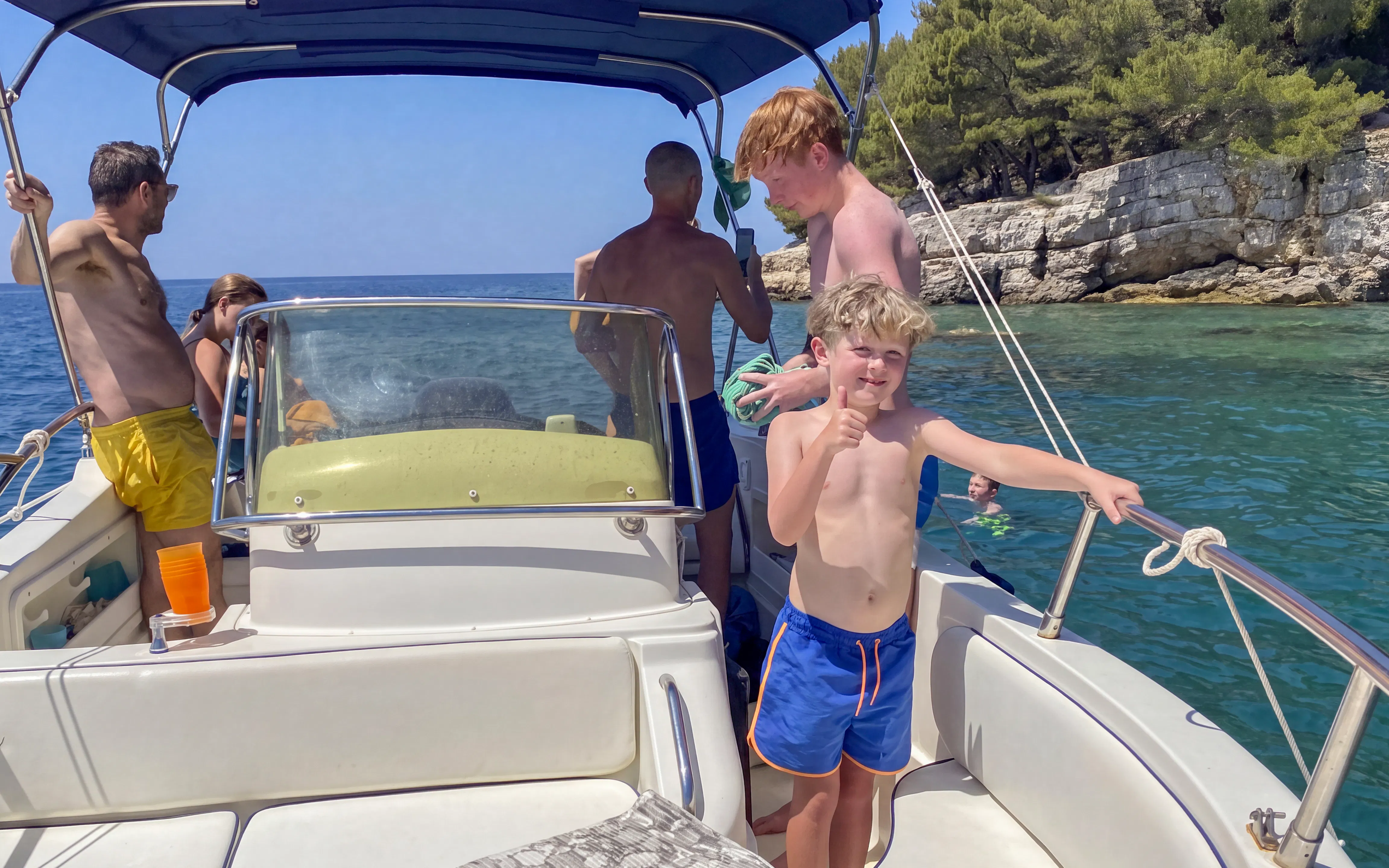Boat tour near Brijuni Islands with people enjoying the sea and scenic coastline.