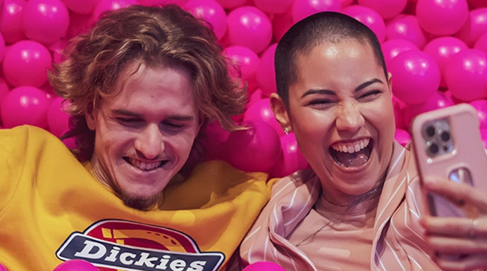 Couple enjoying pink ball pit at Pink Palace Porto.