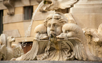 Close-up of fountain sculpture with dolphins at Piazza della Rotonda, near Pantheon, Rome, Italy.