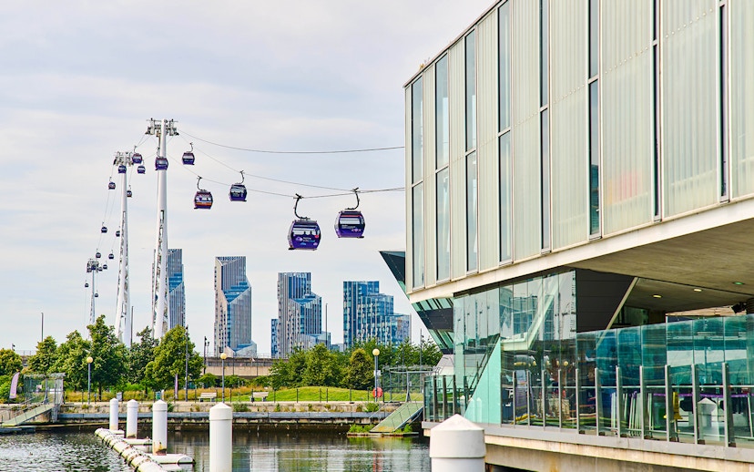 IFS Cloud Cable Car over River Thames in London with city skyline in background.
