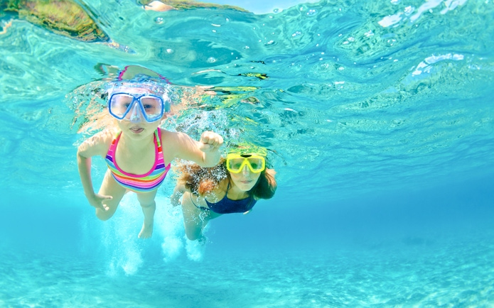 Mother and child snorkeling underwater at White Island, Sharm El-Sheikh.