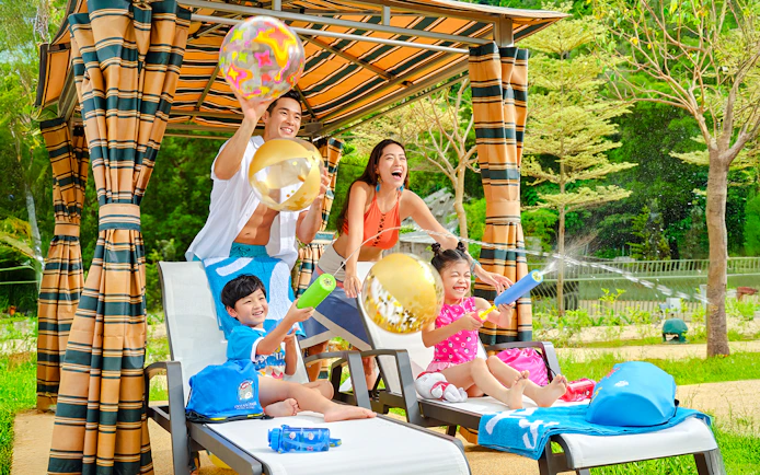 Family playing with water toys by the pool at Water World Ocean Park, Hong Kong.
