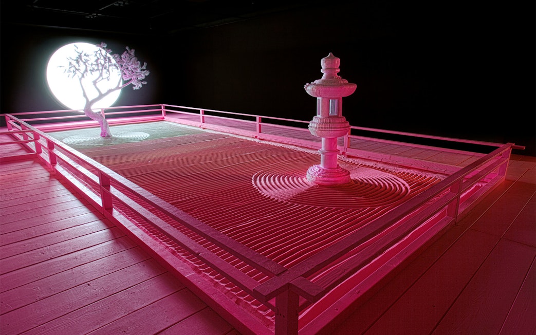 Zen garden with tree and lantern under moonlight at Daniel Arsham's Lunar Garden, Moco Museum London.