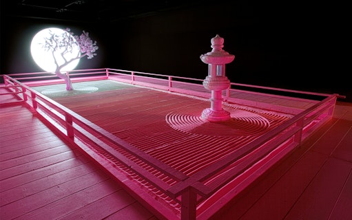 Zen garden with tree and lantern under moonlight at Daniel Arsham's Lunar Garden, Moco Museum London.