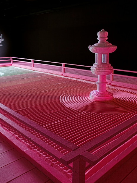 Zen garden with tree and lantern under moonlight at Daniel Arsham's Lunar Garden, Moco Museum London.